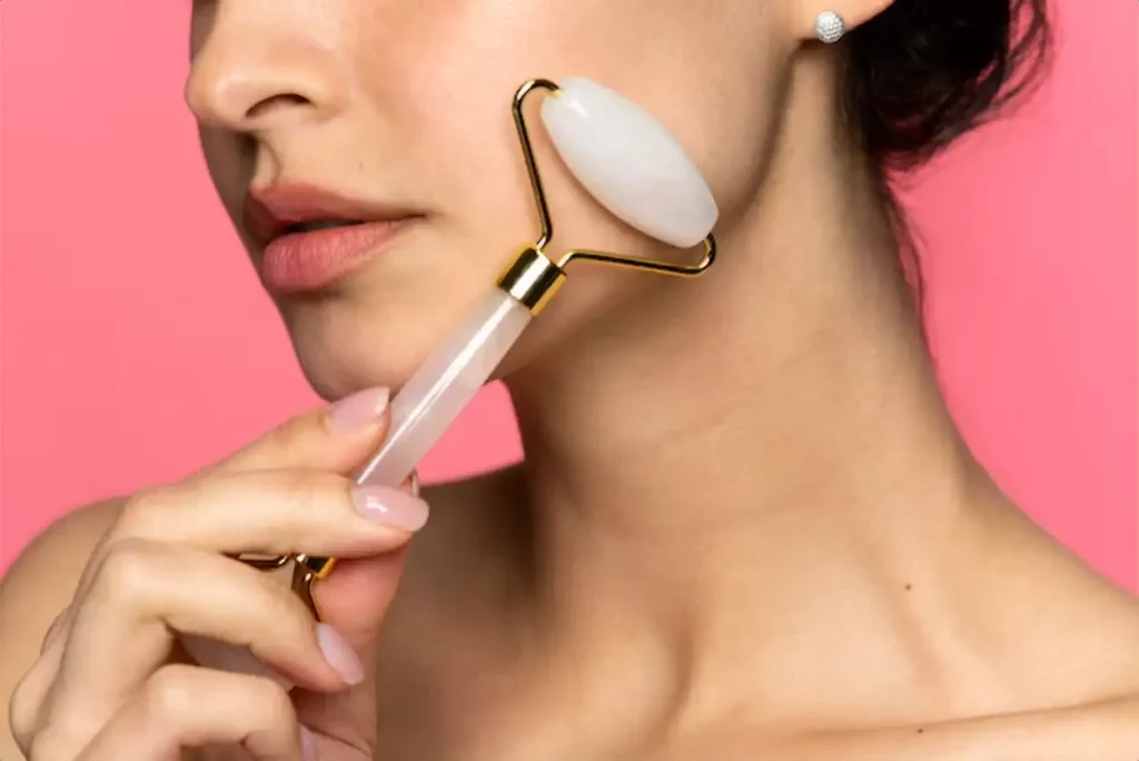 Woman using face roller side view