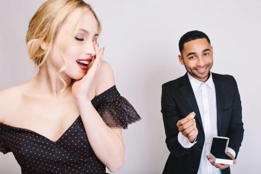 Closeup portrait charming young woman in luxury dress with closed eyes waiting for surprise from handsome guy with ring behind. Celebrating Valentines day, surprise, love.