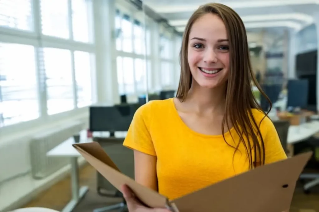 Portrait of female business executive holding a file